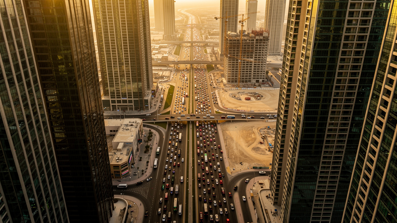 Aerial view of dense Dubai skyscrapers and heavy traffic noise sources