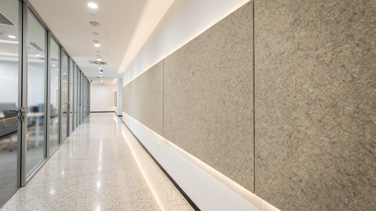 Durable PET acoustic panels lining a high-traffic Dubai office corridor