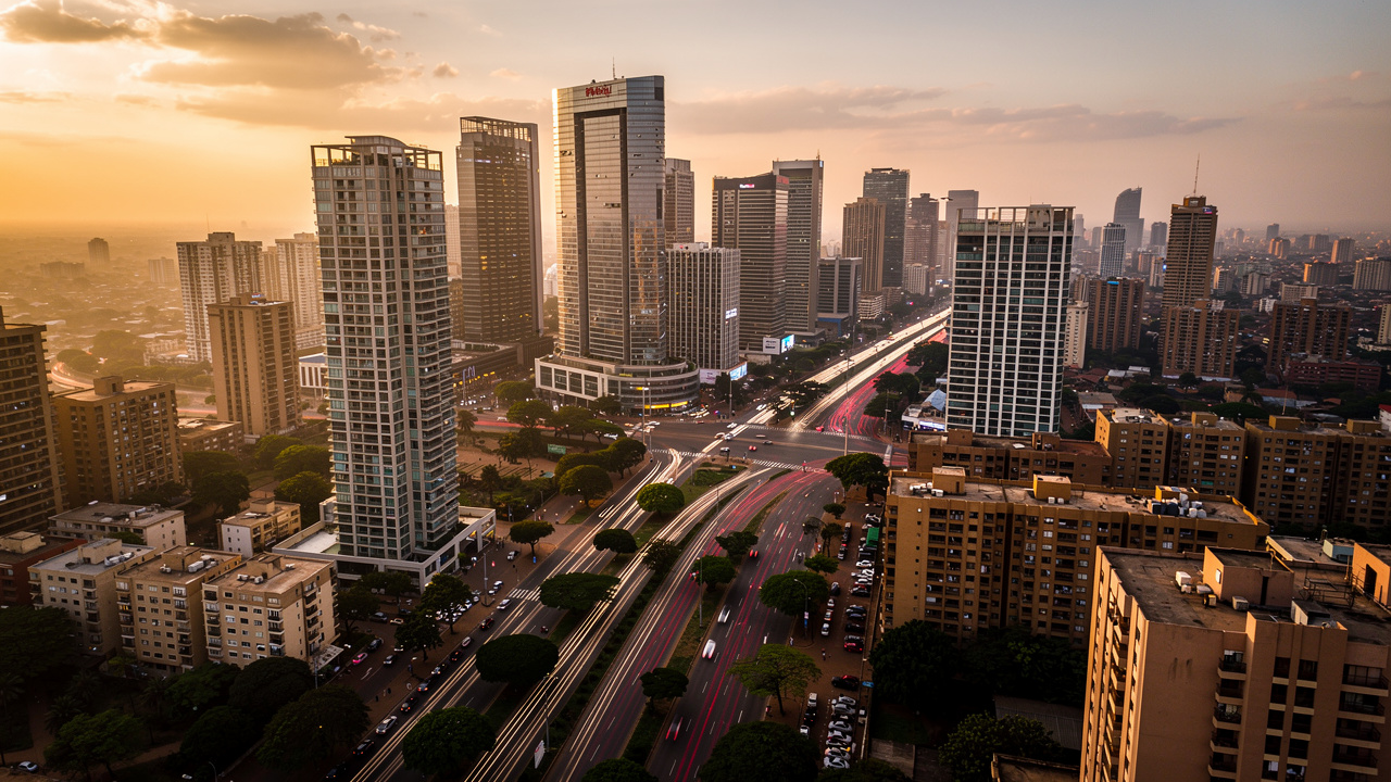 Dense African city skyline with busy roads at golden hour