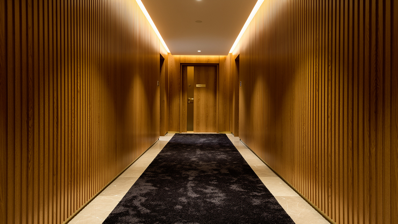 Luxury hotel corridor featuring wood acoustic wall panels